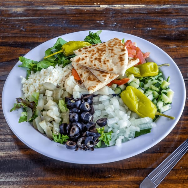 Gyro Guys' Greek salad with pita bread, feta, olives, peppers, and fresh vegetables.