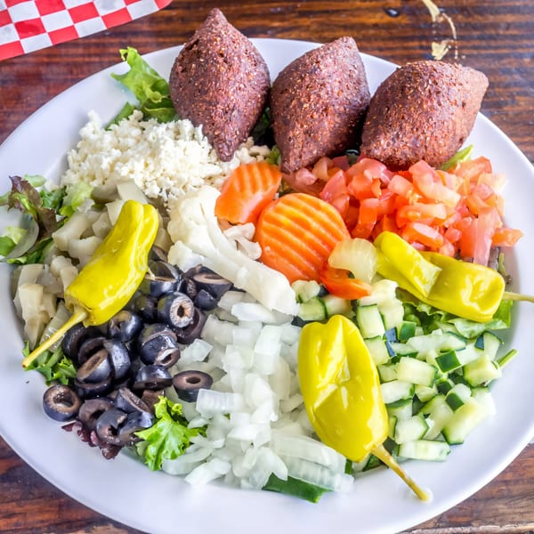 Gyro Guys' kibbeh salad with kibbeh, feta, olives, tomatoes, cucumbers, and banana peppers.